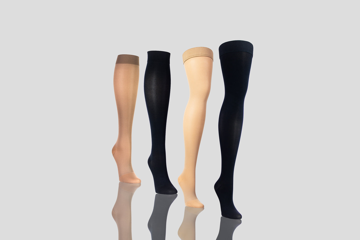 Image Showing 2 Knee High and 2 Thigh High Compression Socks - Both in Beige and Black - Light Grey Background With Shadow